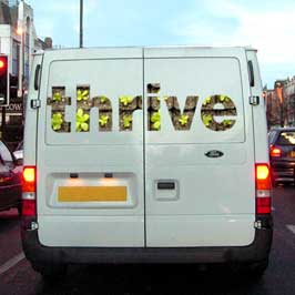 The word 'thrive' printed on the back of a van